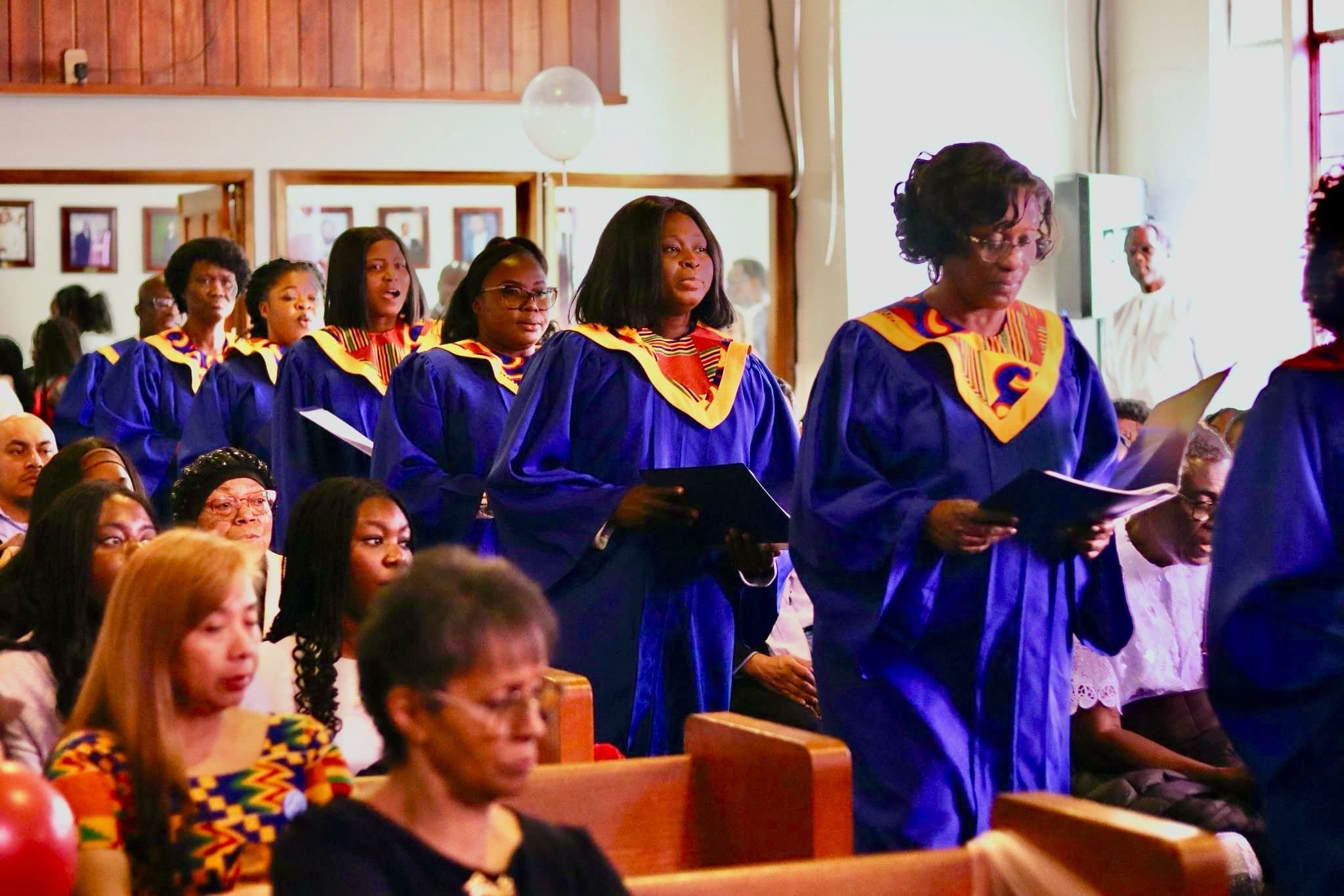 Choir in blue and gold robes during worship